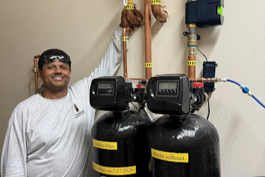 plumbing contractor installing water filtration